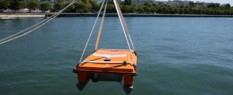 Lowering a WasteShark into the water with straps