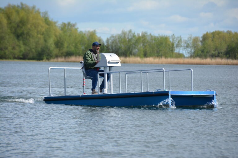 MegaShark vessel on open lake with a person at the helm